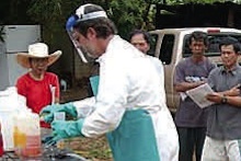 Operator demonstrating proper pesticide safety and PPE